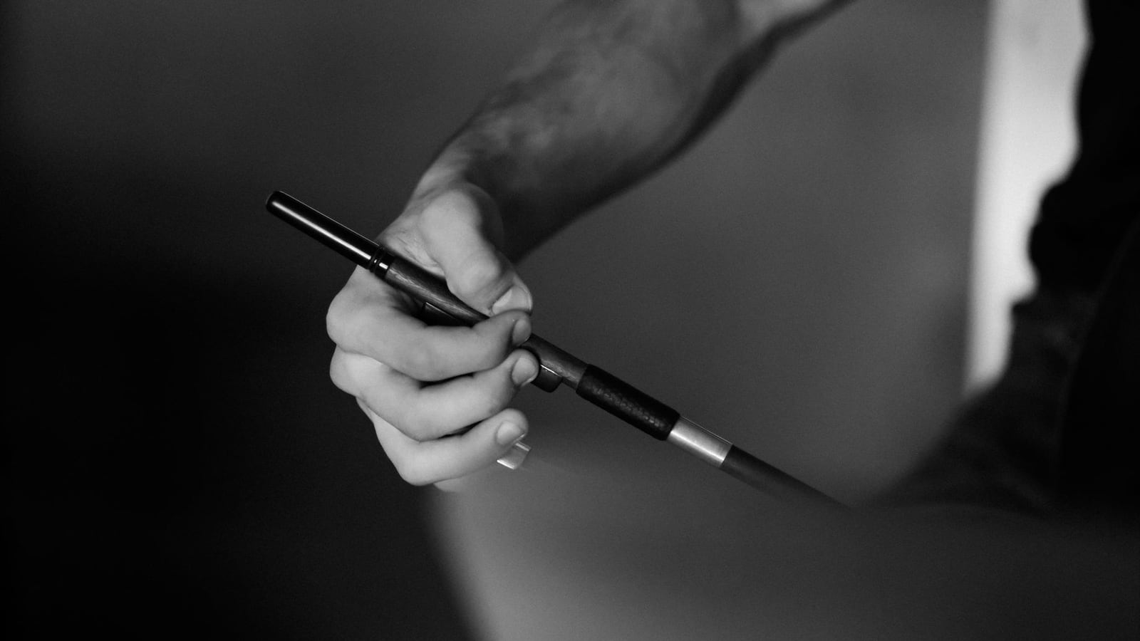 Process of re-hairing a violin bow in the workshop