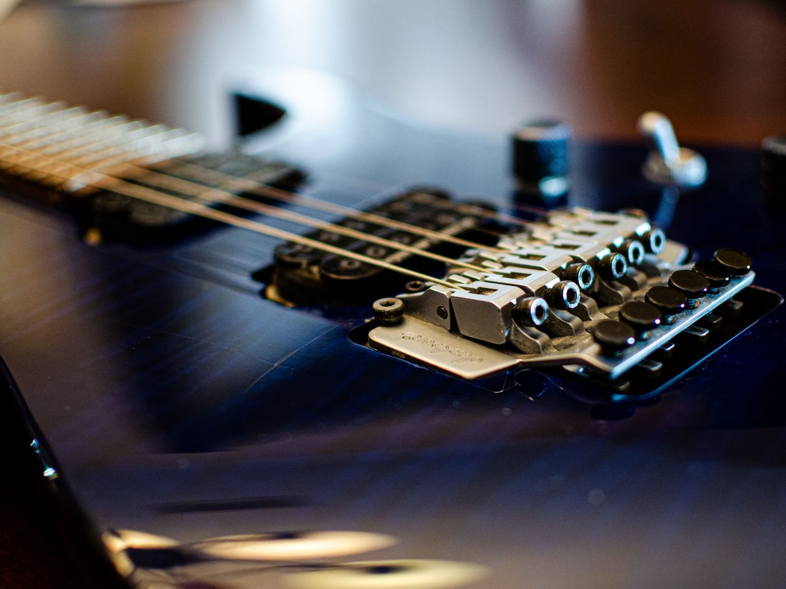 Close-up of a precision adjustment of a guitar bridge in the workshop