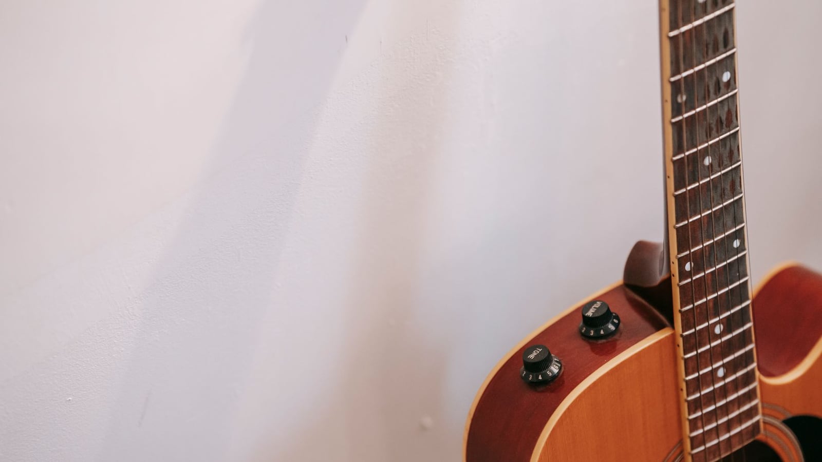 Hygrometer next to a guitar case to monitor humidity