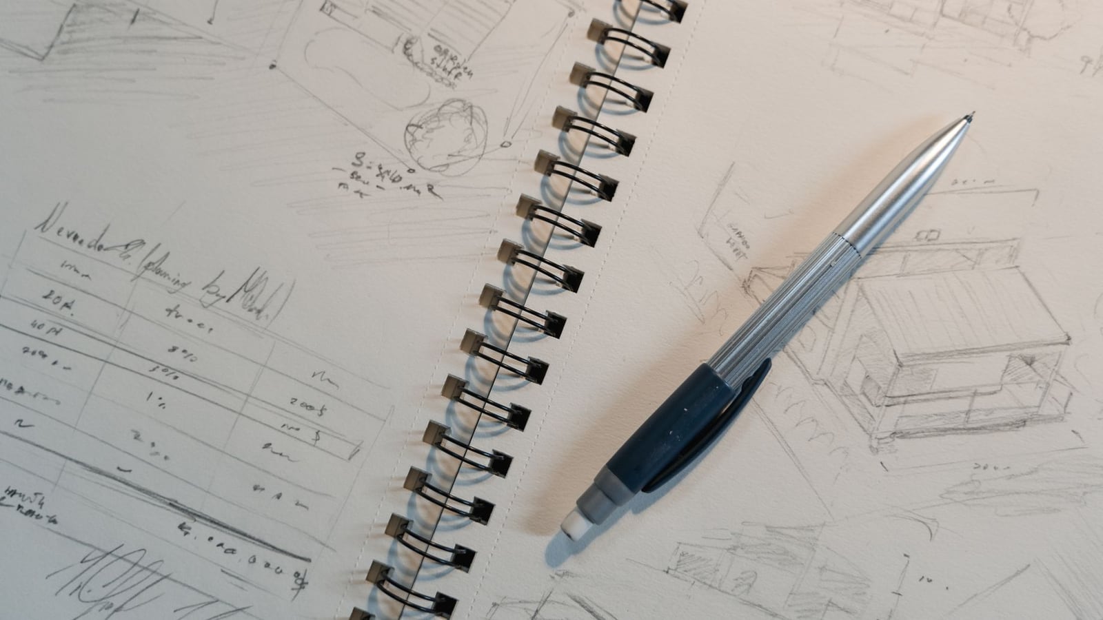 Notes and sketches for instrument adjustment on a workshop table